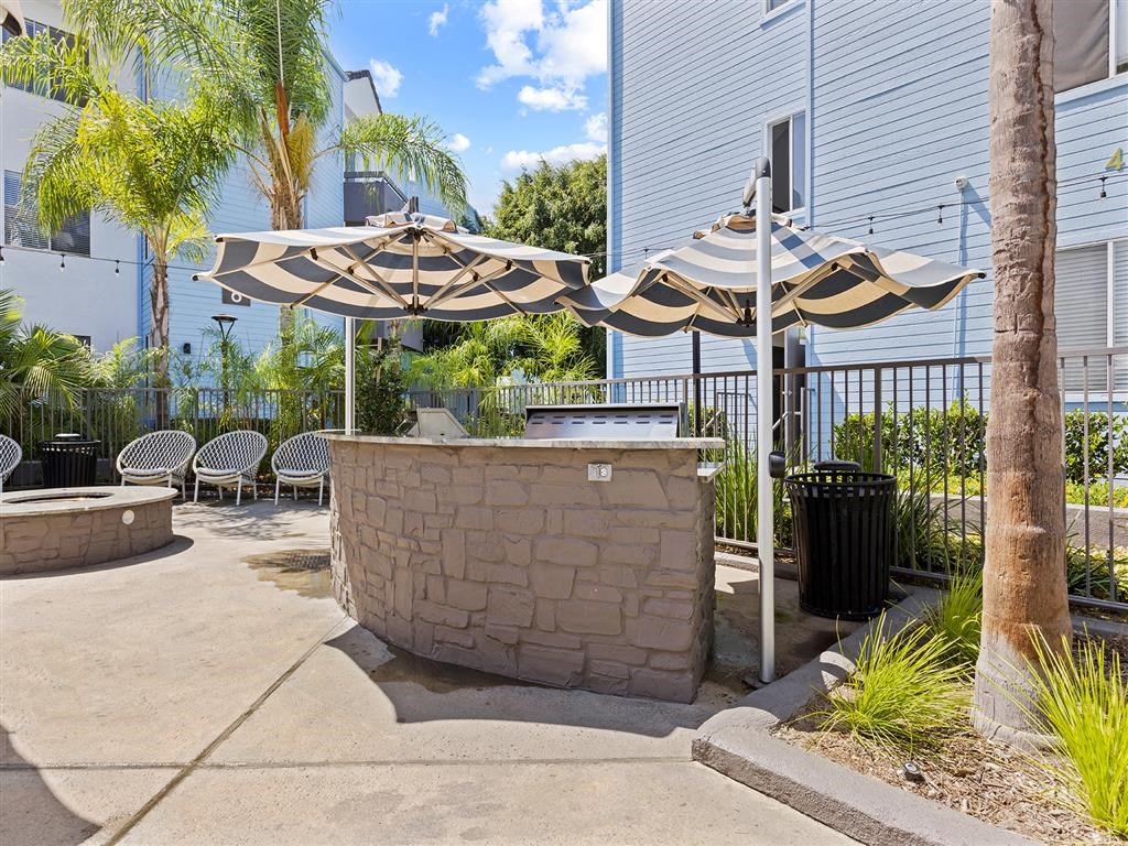 a bar with umbrellas and chairs in a courtyard at Enclave, California