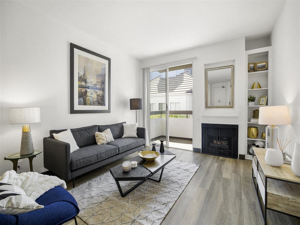a living room with a couch and a fire place at Enclave, Paramount, CA 