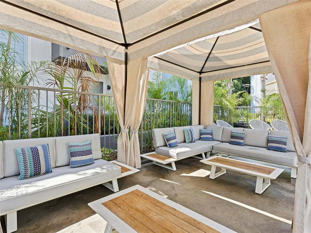 a patio with couches and tables at Enclave, Paramount, 90723