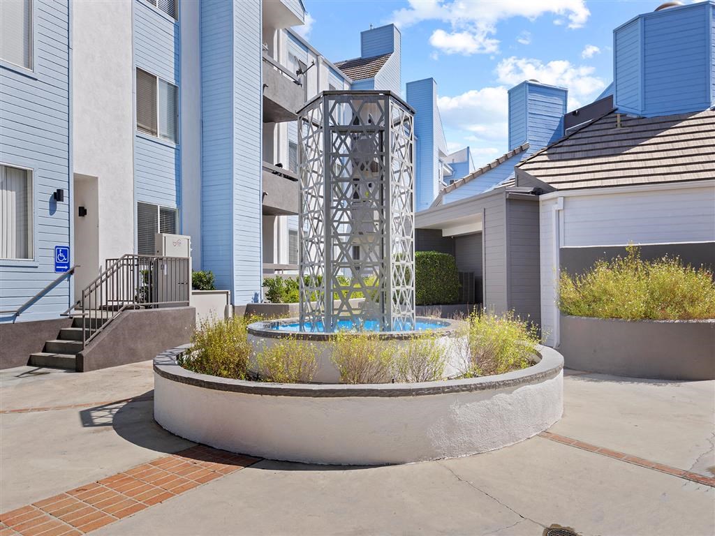 a fountain in front of an apartment building at Enclave, Paramount