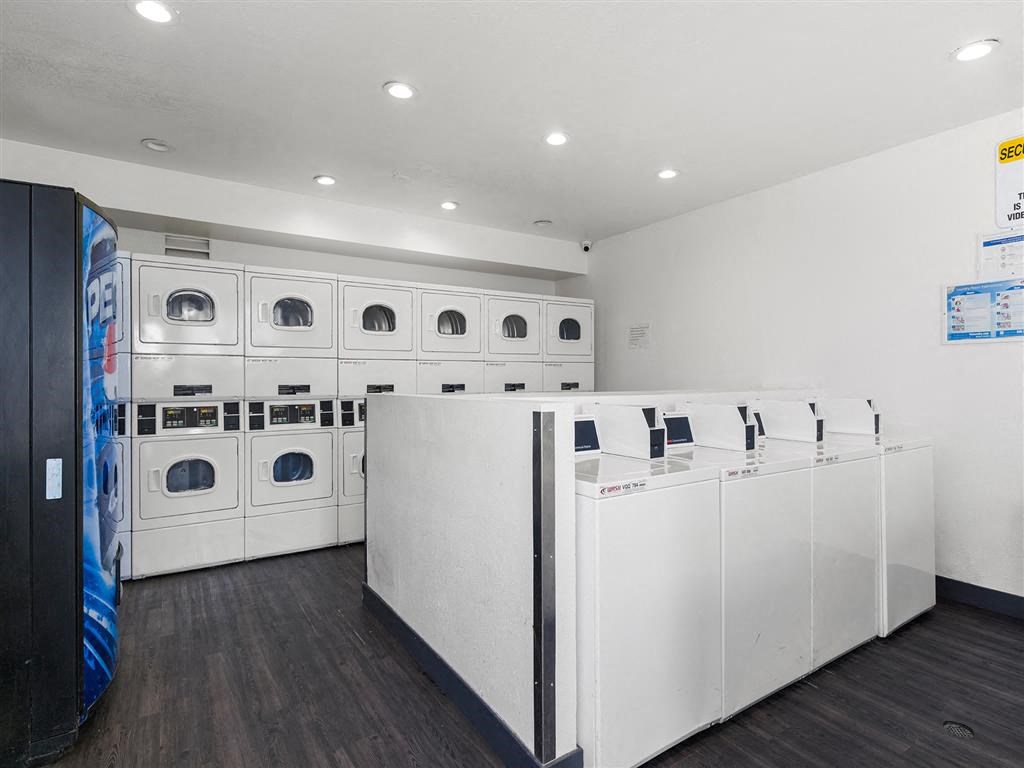 a laundry room with white washers and dryers at Enclave, Paramount, CA 90723