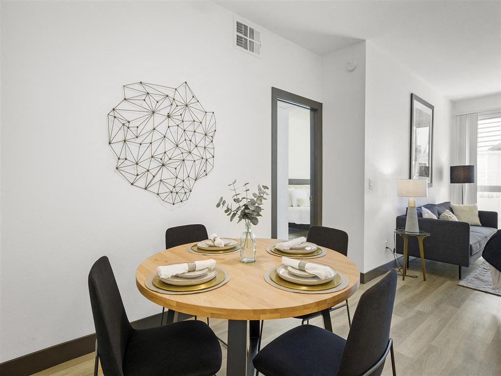 a dining room with a table and chairs a dining room with a table and chairs at Enclave, Paramount California