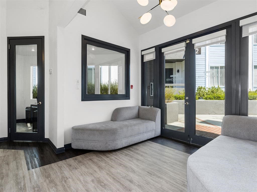 a living room with a couch and a window at Enclave, Paramount, CA