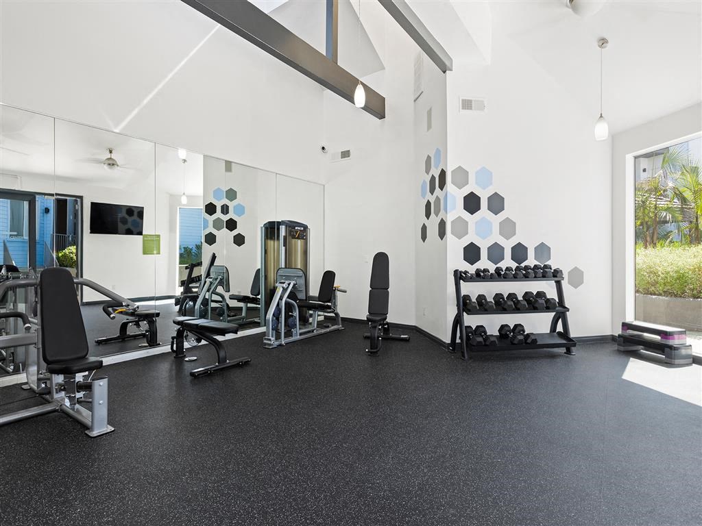a large fitness room with weights and other exercise equipment at Enclave, Paramount California