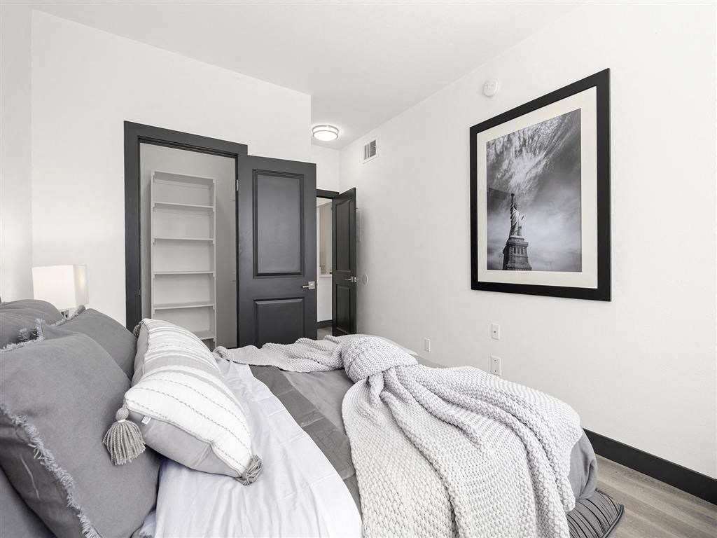 a bedroom with a bed and a door to a bathroom at Enclave, Paramount