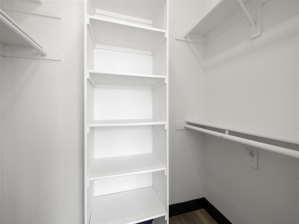 a walk in closet with a white shelving unit at Enclave, Paramount, 90723