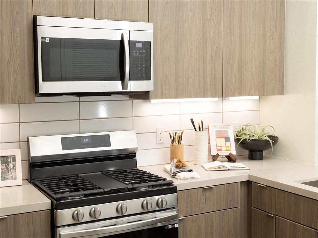 a kitchen with a stove and a microwave