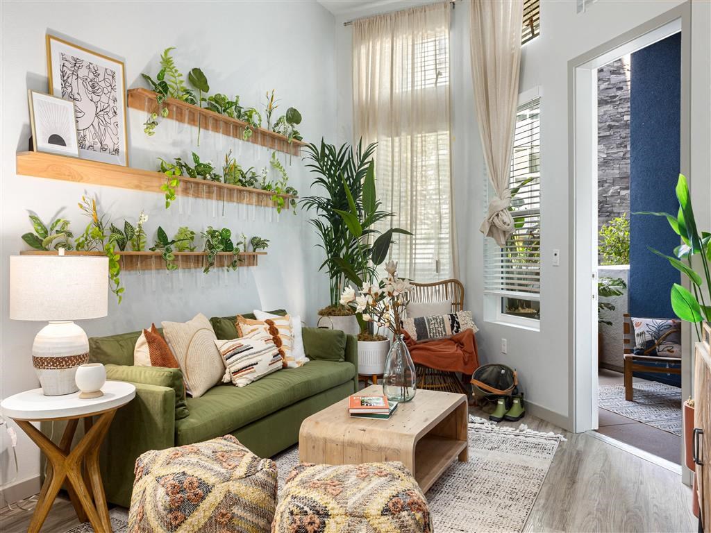 a living room with a green couch and plants
