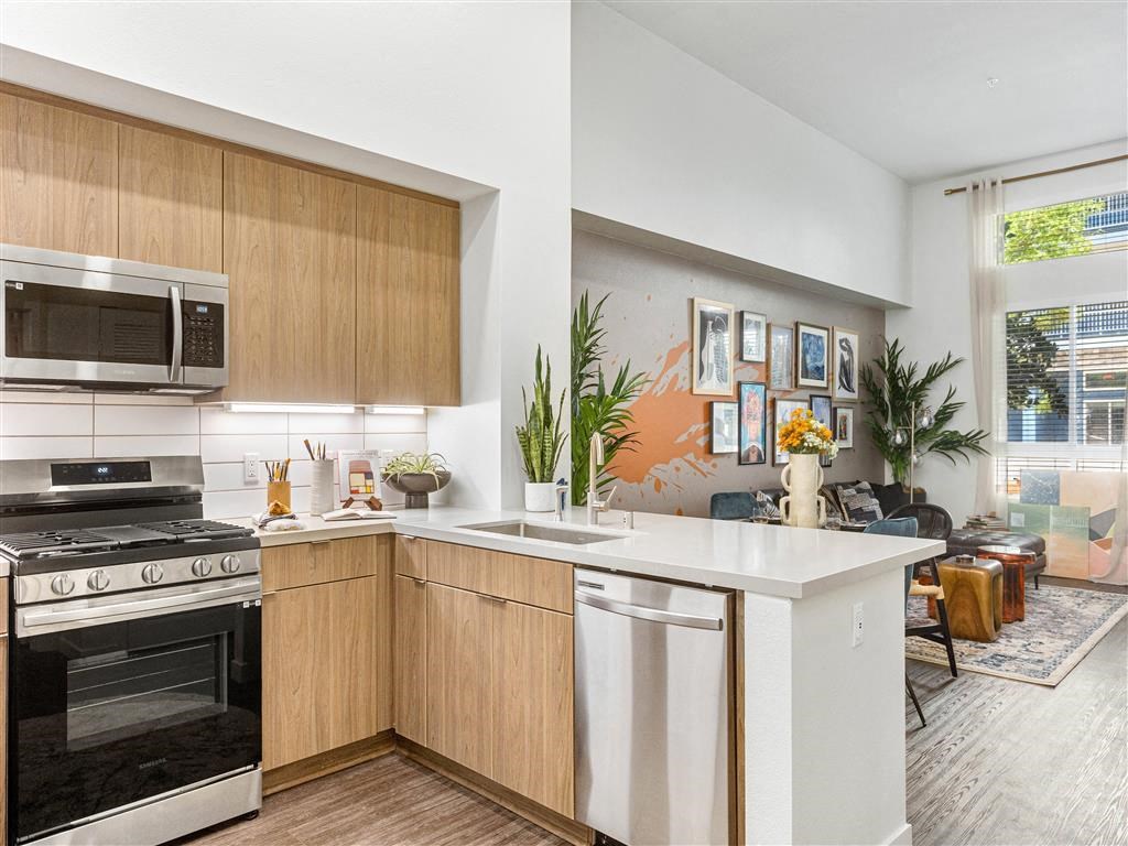 a kitchen with an island and a stove and a microwave
