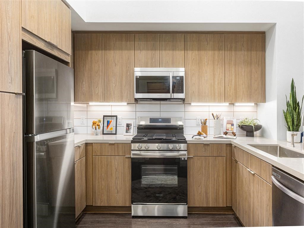 a kitchen with stainless steel appliances and wooden cabinets