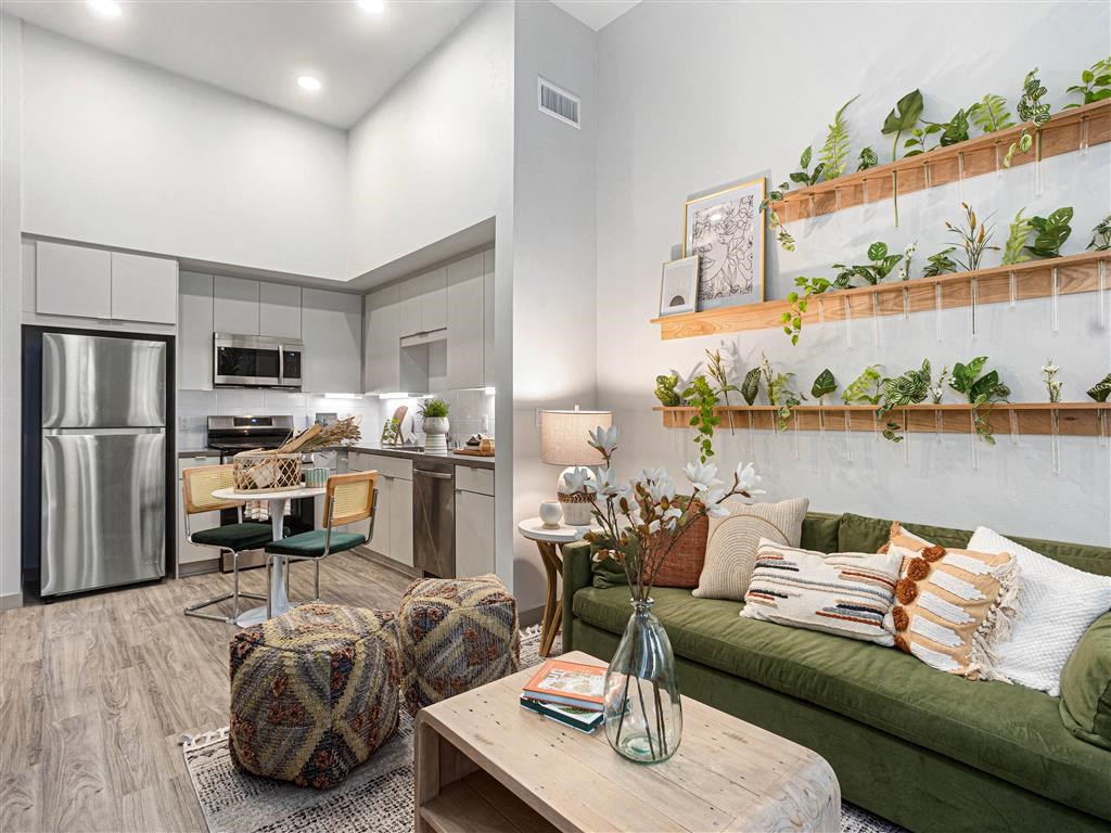 a living room and kitchen with a couch and a table