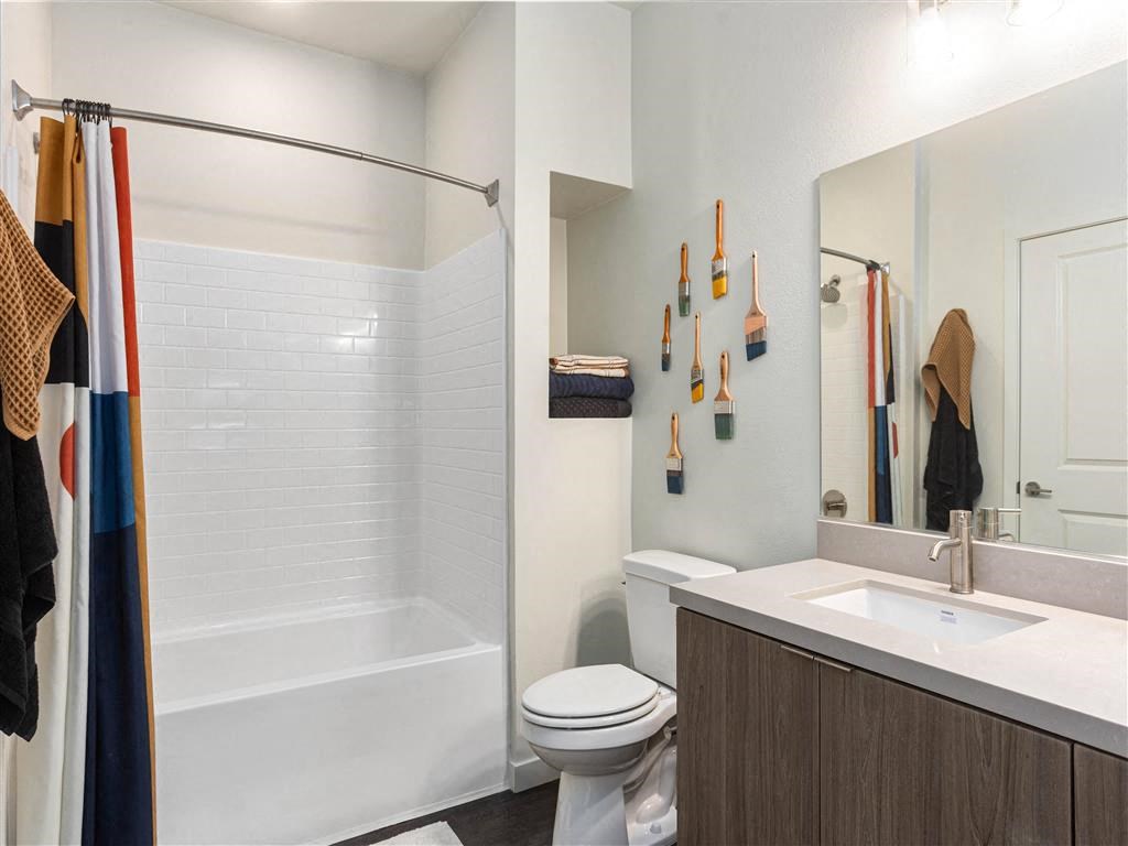 a bathroom with a shower toilet sink and mirror