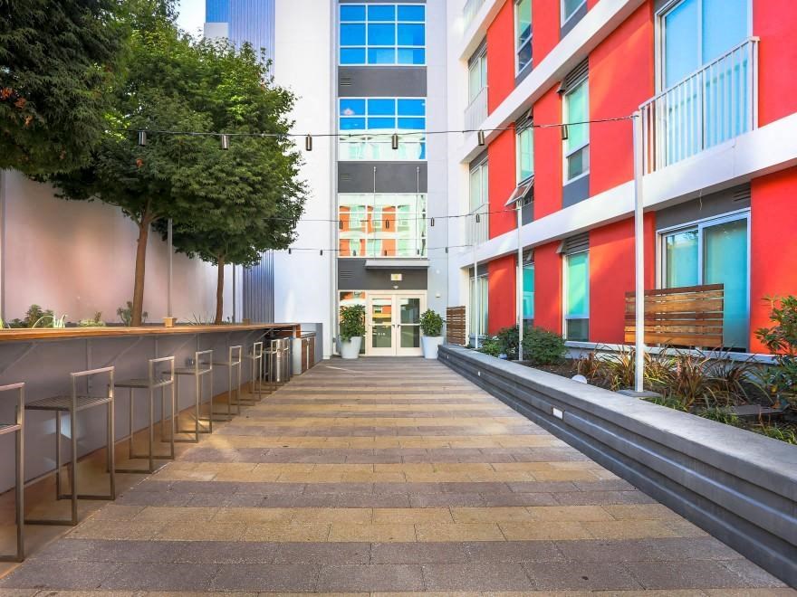 an empty sidewalk in front of some buildings