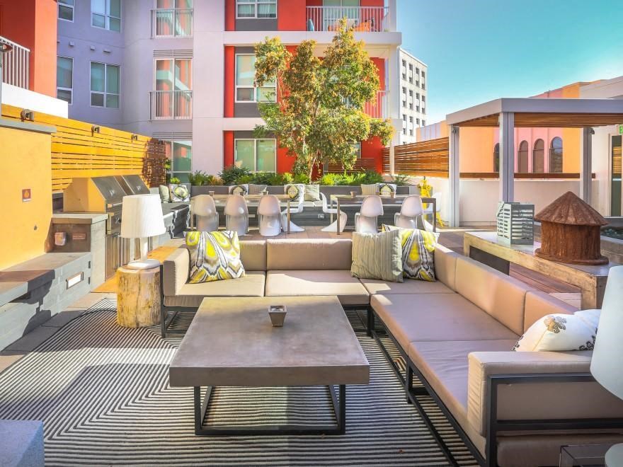 a lounge area of a hotel with couches and tables