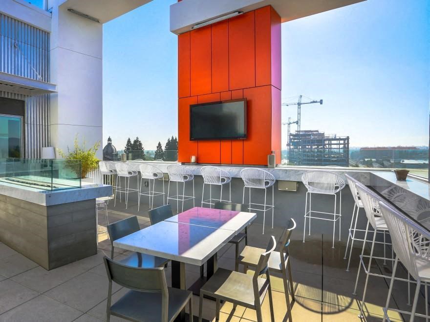a patio with tables and chairs and a television