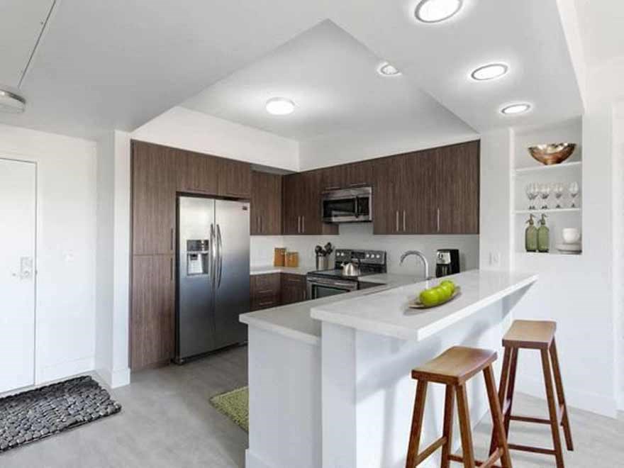 a kitchen with a counter and bar stools
