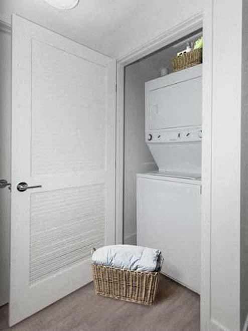 a bathroom with a white door and a basket on the floor