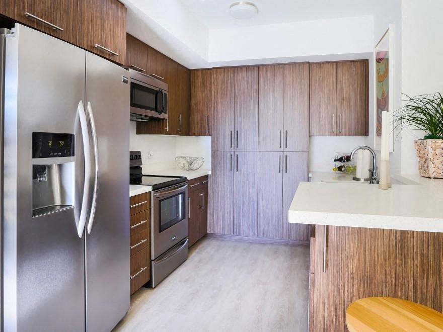 a kitchen with stainless steel appliances and wooden cabinets
