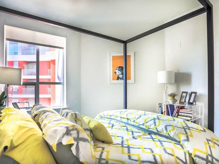 a bedroom with a bed and a window