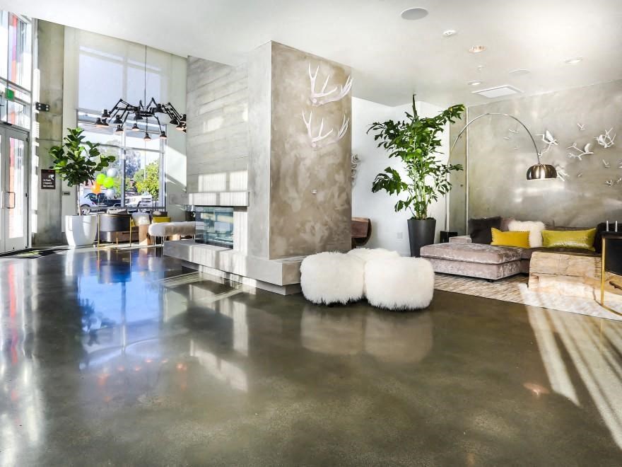 the lobby of the building has seating and plants