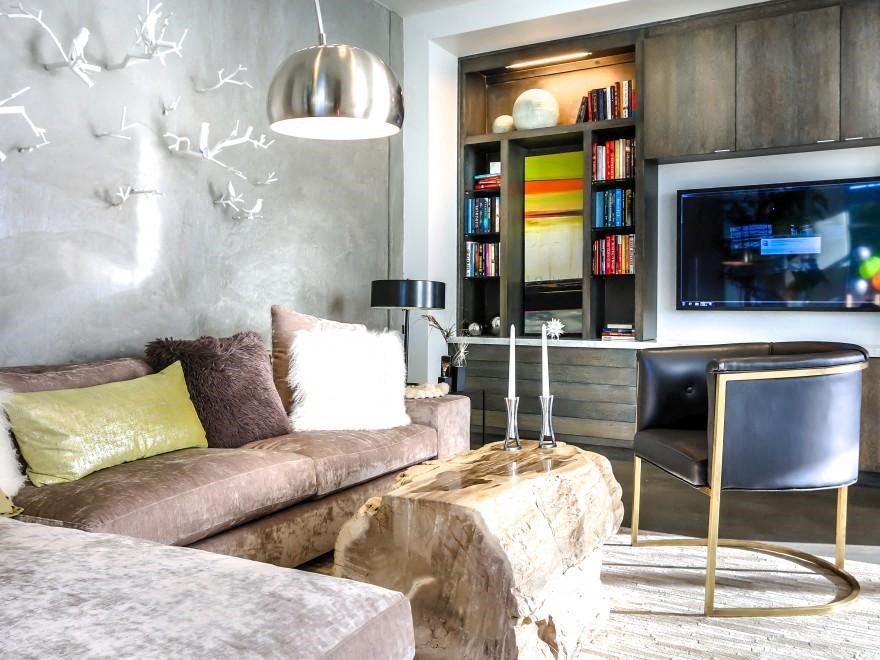 a living room with a couch and a chair and a television