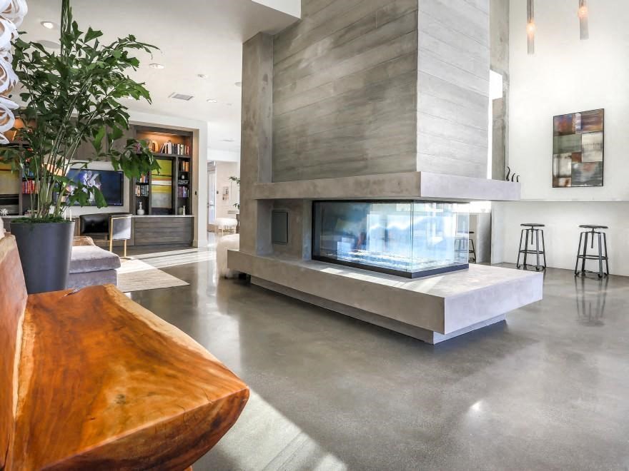 the living room has a large fireplace with an aquarium in it