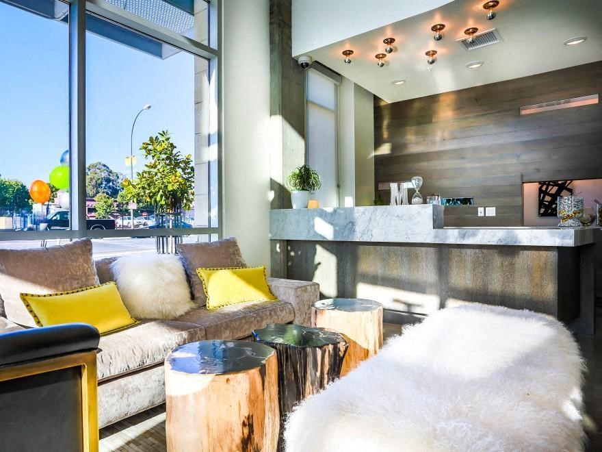 the lobby of a hotel with couches and a reception desk