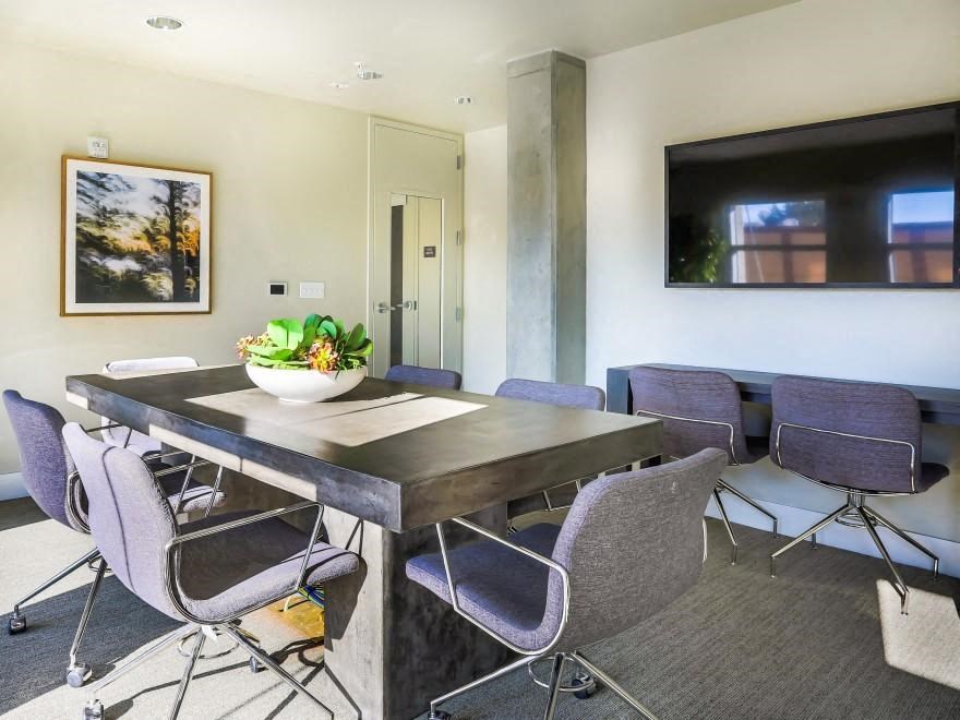 a conference room with a table and chairs