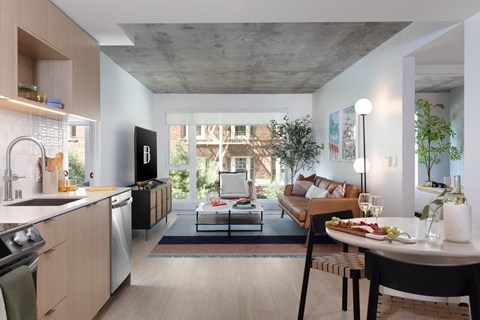 a living room with a couch and a table  and a kitchen