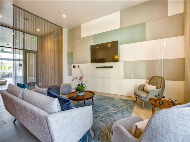 a living room with couches and chairs and a television