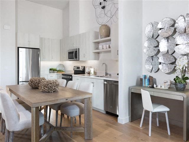 a kitchen and dining room with a table and chairs