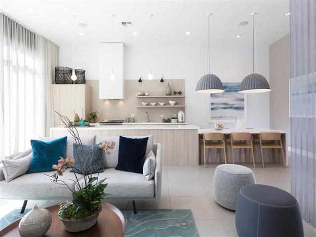 a living room with a couch and a kitchen