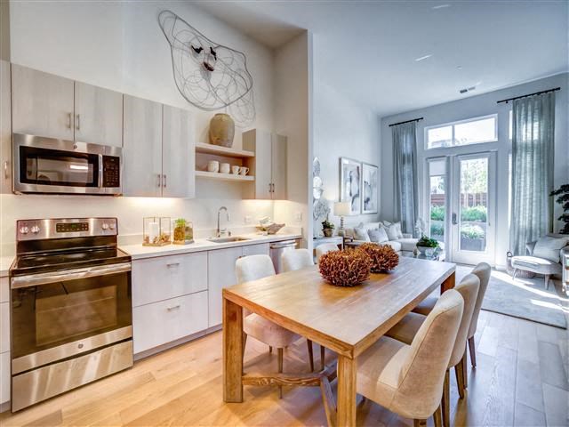 a kitchen and dining room with a wooden table