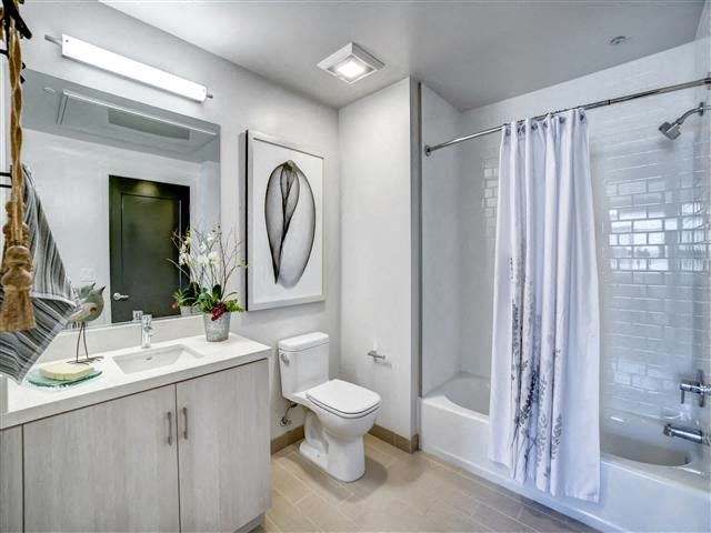 a bathroom with a toilet and a sink and a shower