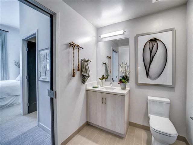 a bathroom with a toilet and a sink and a mirror