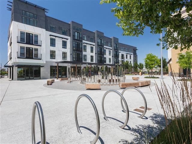 an empty playground in front of an apartment building