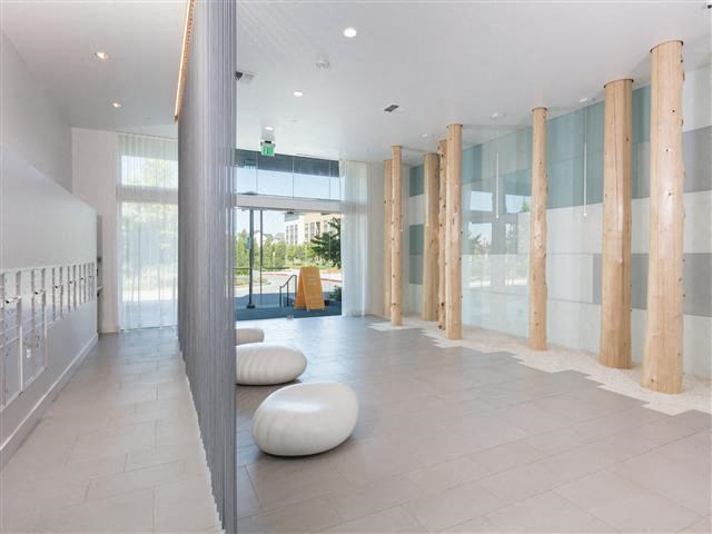 a large room with benches and a glass door