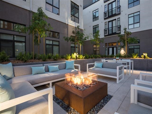 a seating area with couches and a fire pit