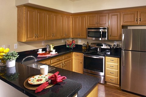 a kitchen with stainless steel appliances and wooden cabinets