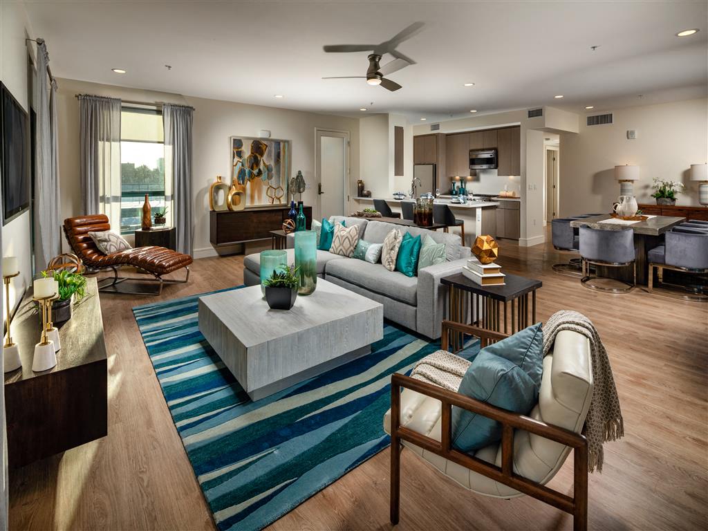 A living room with a blue rug and a brown chair.