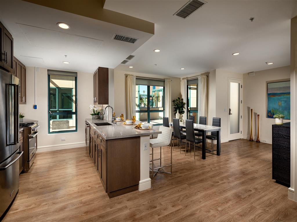 A modern kitchen with a dining table and chairs.