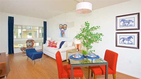 a living room with a table and chairs and a couch