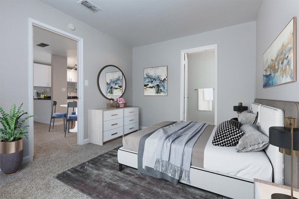 a bedroom with a bed and a dresser and a mirror