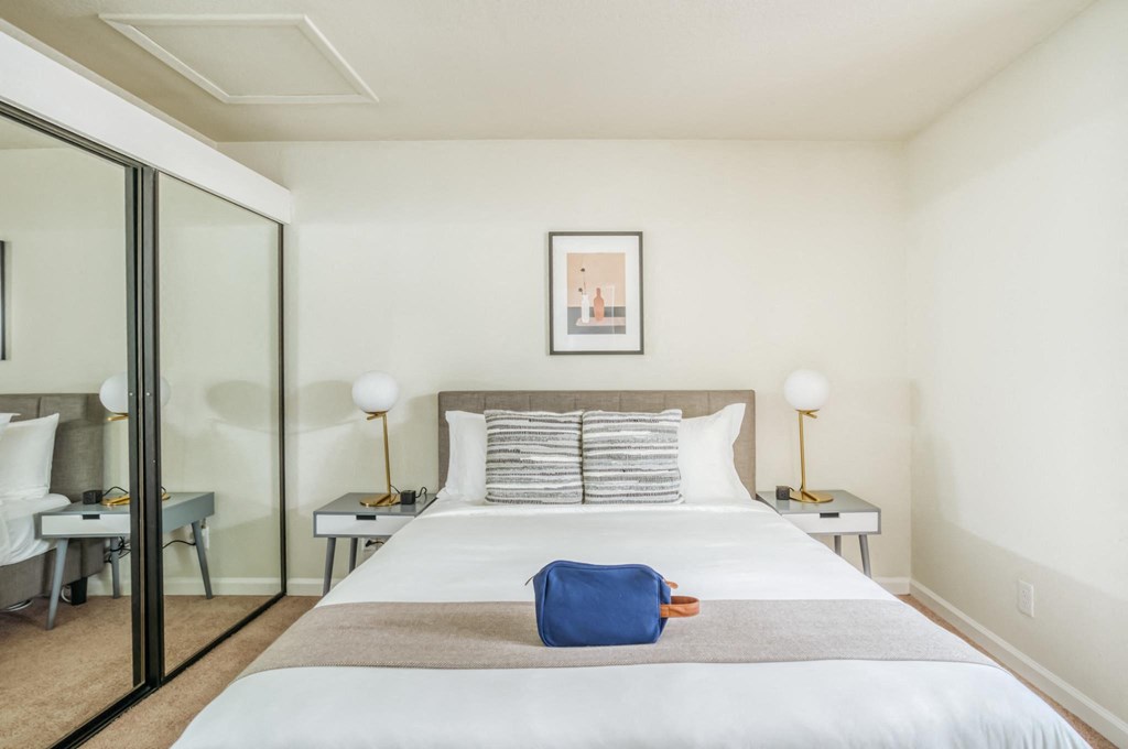 a bedroom with a large bed and a sliding glass door