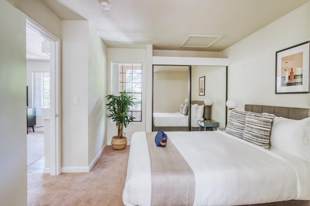 a bedroom with a large bed and a window