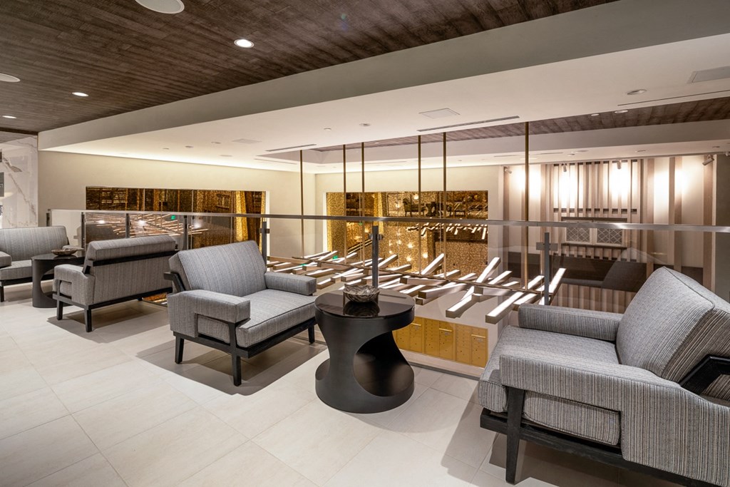 the lobby of a club with chairs and a bar