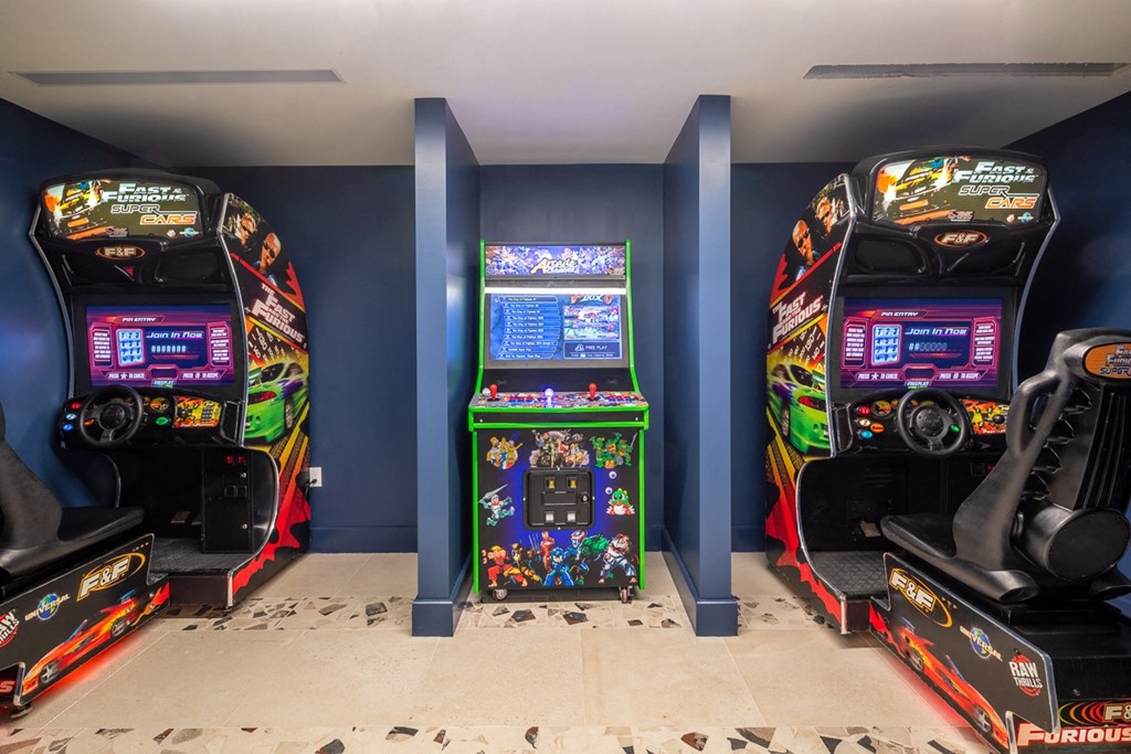 two arcade games in a room with blue walls