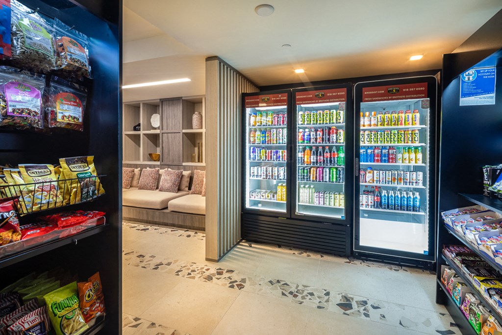 a convenience store with two refrigerators and a display case of drinks and snacks