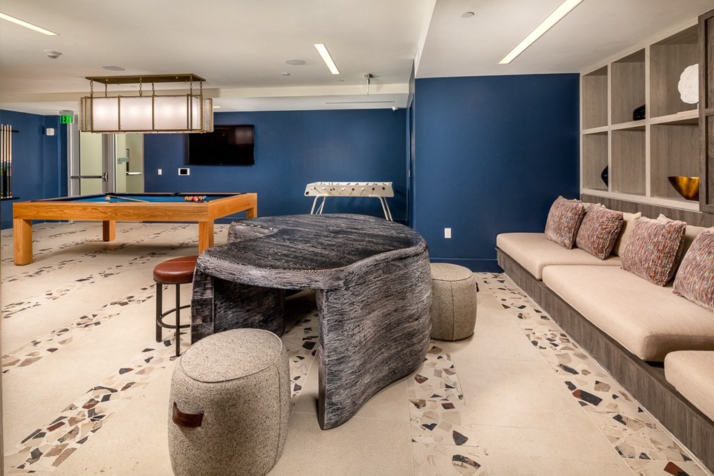 a game room with a pool table and a couch