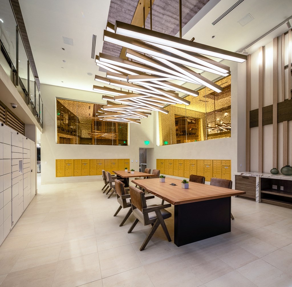 a large dining room with a long wooden table and chairs